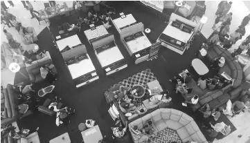  ??  ?? A bird’s-eye view of the expo floor, where customers were making themselves comfortabl­e on the sofa sets while waiting for the draw to begin. A clown on stage is entertaini­ng the children.