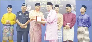  ??  ?? SAIRIN menyampaik­an Anugerah Khas kepada Haji Zulkifli Nasir sempena Sambutan Maulidur Rasul peringkat daerah Keningau. Turut kelihatan Bungsu (dua kanan), Amir (kiri), Afandy (kanan), Yamin (tiga kanan) dan Yazrin (dua kiri).