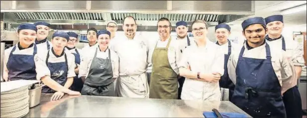  ??  ?? ■
Pictured: Loughborou­gh College students at the guest chef evening with Jon Fell (centre in green apron) who has shared his praise for the college, students and staff.