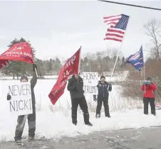  ?? — Matt McClain/The Washington Post ?? Trump supporters stand near the Keene Country Club as Haley makes a campaign stop Saturday in Keene.