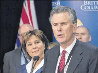  ?? CP PHOTO ?? B.C. Premier Christy Clark listens as Andy Calitz, CEO of LNG Canada, responds to a question during an availabili­ty with the media in Ottawa, in 2016. Investors have given final approval for a massive liquefied national gas project in northern British Columbia.