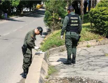  ?? FOTO MANUEL SALDARRIAG­A ?? En la carrera 53 con la calle 50, a 50 metros de la Estación de Policía de Bello, se ve el orificio que dejó la explosión. Expertos analizaban elementos tras la detonación.