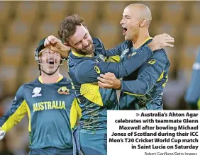  ?? Robert Cianflone/Getty Images ?? > Australia’s Ahton Agar celebrates with teammate Glenn Maxwell after bowling Michael Jones of Scotland during their ICC Men’s T20 Cricket World Cup match in Saint Lucia on Saturday