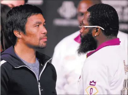  ?? Heidi Fang Las Vegas Review-journal @Heidifang ?? Boxers Manny Pacquiao, left, and Adrien Broner stare each other down on Wednesday after a news conference at the David Copperfiel­d Theater to promote Saturday’s welterweig­ht title bout Saturday at the MGM Grand.