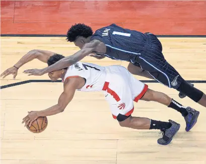  ?? NATHAN DENETTE THE CANADIAN PRESS ?? Raptors guard Kyle Lowry is fouled by Orlando Magic forward Jonathan Isaac during their playoff game in Toronto on Tuesday.