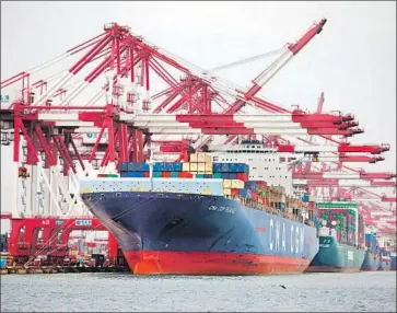  ?? VCG via Getty Images ?? CRANES unload shipping containers in China. The U.S. trade deficit with China is only one of the issues in the economic relationsh­ip between the two countries that prompted President Trump to impose tariffs.