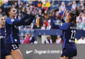  ?? The Associated Press ?? ■ San Diego Wave forward Alex Morgan (13) is greeted by midfielder Taylor Kornieck (22) after Morgan scored a goal against the OL Reign during the first half on April 14 in Seattle.