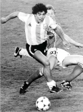  ??  ?? In this June 13, 1982 file photo, Argentina's Diego Maradona, front, is attacked by Belgium's Guy Vandermiss­en