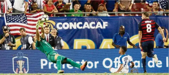  ?? — AFP ?? Snuffed: US forward Jordan Morris watches as his attempt is saved by Martinique goalkeeper Kevin Olimpa in the Gold Cup Group B match in Florida on Wednesday.