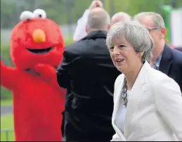  ??  ?? WHO’S THAT MUPPET? Elmo greeted Tory May at Sonning’s scout hut