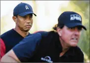  ?? HOW / GETTY IMAGES FOR THE MATCH PHOTO BY HARRY ?? Tiger Woods looks on as Phil Mickelson plays from the 14th tee during The Match: Tiger vs Phil at Shadow Creek Golf Course on Nov. 23 in Las Vegas, Nev.