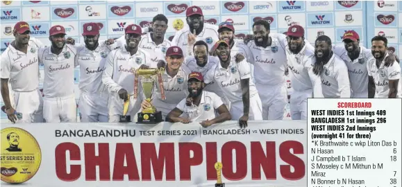  ?? (Photos: AFP) ?? West Indies players pose with the Test tournament trophy after winning the second Test cricket match against Bangladesh at Sher-e-bangla National Cricket Stadium in Dhaka yesterday.