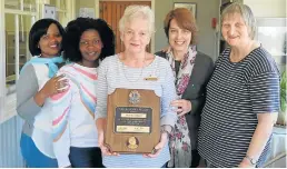  ?? Picture: BOB FORD ?? CARING FOR OTHERS: Part of the team responsibl­e for running the Sunshine Coast Hospice in Port Alfred is, from left, data capturer Olga Shuping, social auxiliary worker Nomonde Moses, administra­tor Zelda Elliott with her award, corporate fundraiser Angela Hibbert and volunteer Hilary Smith