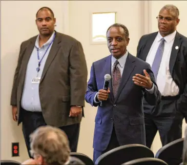  ?? MIGUEL MARTINEZ / FOR THE AJC ?? DeKalb County CEO Michael Thurmond, flanked by officials from the Department of Watershed Management, addresses Decatur residents at a meeting in March about sewer spill issues.