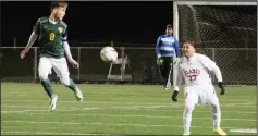  ?? MIKE BUSH/NEWS-SENTINEL ?? Lodi defender Juan Romero (17) waits for the ball, while Tracy's Toby Webb watches in Tuesday's TCAL opener at the Grape Bowl. The Flames lost a tough one to the Bulldogs, 3-2.