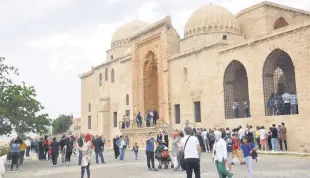  ?? ?? People are seen near a historic site in the southeaste­rn province of Mardin, once home to many civilizati­ons throughout history, Turkey, May 4, 2022.