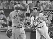  ?? MARK J. TERRILL/AP PHOTO ?? The Dodgers’ Justin Turner watches his two-run home run off Houston starting pitcher Dallas Keuchel during the sixth inning of Game 1 of the World Series on Tuesday in Los Angeles. The Dodgers won, 3-1.