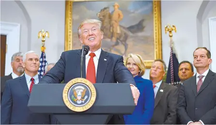  ?? AFP-Yonhap ?? U.S. President Donald Trump speaks before signing an executive order on health insurance in the Roosevelt Room of the White House in Washington, D.C., Thursday.