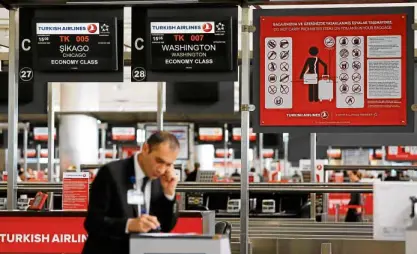  ?? —REUTERS ?? An employee stands at a Turkish Airlines counter for US bound flights at Ataturk Internatio­nal airport in Istanbul, Turkey.