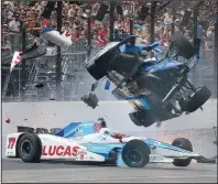  ?? AP/RON GRAPHMAN ?? Indianapol­is 500 pole-sitter Scott Dixon (right) goes airborne in his car after crashing into Jay Howard after coming out of the first turn during Sunday’s race. Dixon and Howard were both examined by medical personnel and came away from the accident...
