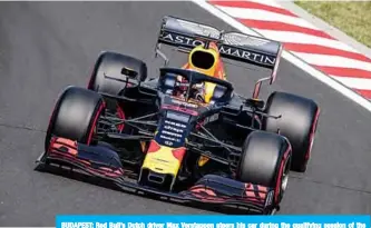  ?? —AFP ?? BUDAPEST: Red Bull’s Dutch driver Max Verstappen steers his car during the qualifying session of the Formula One Hungarian Grand Prix at the Hungarorin­g circuit.