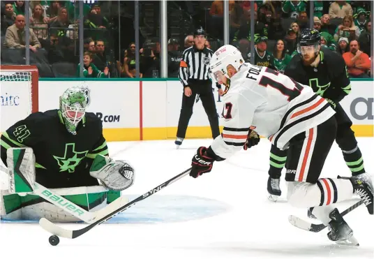  ?? RICHARD W. RODRIGUEZ/AP ?? Blackhawks left wing Nick Foligno tries to set up a shot against Stars goaltender Scott Wedgewood in the second period Sunday.