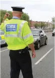  ??  ?? A member of the Garda Traffic Corps during a checkpoint