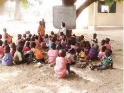  ??  ?? There are no enough classroms here as some pupils take lesson under a tree