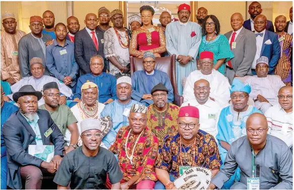  ??  ?? President Muhammadu Buhari (middle) with members of his delegation and some Nigerians resident in South Africa during his meeting with them in Pretoria… yesterday.