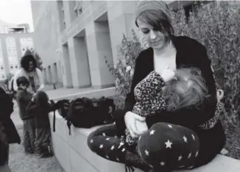  ?? Craig F. Walker, The Denver Post ?? Rochelle Bricker breast-feeds daughter Penelope, 2, during a "nurse-in" at the Downtown Detention Center. Bricker was ordered to stop breast-feeding Nov. 26 by a deputy.