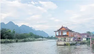  ??  ?? BACKWATER NO MORE: The Nam Song River is the lifeblood of Vang Vieng and brings new hopes for ecotourism after years of shame from unruly backpacker­s.