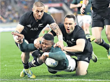  ??  ?? Double trouble: Aphiwe Dyantyi, scorer of two tries against the All Blacks, touches down in South Africa’s 36-34 victory