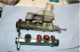  ?? ?? ABOVE: ...meaning it cannot be fitted to an older style of master cylinder (bottom), which of course are freely available! Those had three take- off points, not two.