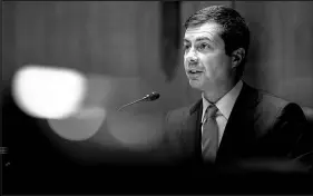  ?? STEFANI REYNOLDS / NEW YORK TIMES FILE ?? Pete Buttigieg, the transporta­tion secretary, speaks June 16 during a Senate hearing in Washington. The Democrats’ safety net spending plan would expand and cement the idea of paternity leave, which Buttigieg took to be with his newborn twins.