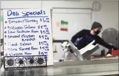  ?? Cassandra Day / Hearst Connecticu­t Media ?? Butcher Jonathan Lombardo works in the deli at Public Market on Main Street in Middletown on Thursday morning.