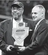  ?? Karen Warren / Staff photograph­er ?? Watson is awarded the B.A.T Lifetime Achievemen­t award by commisione­r Rob Manfred before a game in 2017.