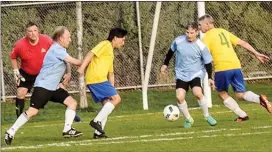  ?? Special to the Herald ?? Penticton TC Auto’s Rob Kroeker tries to control the ball in front of goalkeeper Pat Vanryswyk as fellow defender Grant Rutherglen looks on during 55-and-over oldtimers’ soccer league play Thursday at King’s Park. Penticton won 4-0.