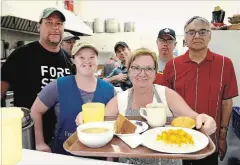  ?? MELINDA CHEEVERS METROLAND ?? Jocelyn Laing, in front, serves up a tray of lunch at Oznam Centre's $1 lunch program, joined by, from left, co-ordinator Chuck Spry and volunteers Charlie, Jesse, Michale, Derek, and Stephen.