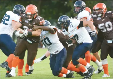  ?? GARY NYLANDER/Okanagan Weekend ?? The Okanagan Sun and the Kamloops Broncos clash tonight at the Apple Bowl. During a game last year at the Apple Bowl, which the Sun won, Kasey Russell carried the ball as Kamloops Broncos Ryan Derksen tried to bring him down.