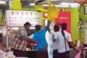  ??  ?? A video grab of the clip that went viral showing men throwing chairs and beer bottles at a restaurant in Stulang Laut in Johor Baru on Saturday.