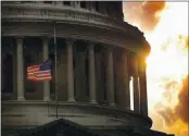  ?? DOUG MILLS — THE ASSOCIATED PRESS, FILE ?? A flag flies at half-staff on Capitol Hill on July 24, 1998, in honor of two Capitol police officers who were killed after a gunman burst through security barriers. A woman tourist was also seriously wounded in the incident and hospitaliz­ed for her injuries.