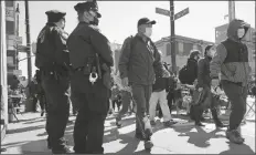  ?? KATHY WILLENS/AP ?? TWO NEW YORK CITY POLICE OFFICERS patrol a busy intersecti­on on Main Street in Flushing, a largely Asian American neighborho­od, March 30, in the Queens borough, N.Y.