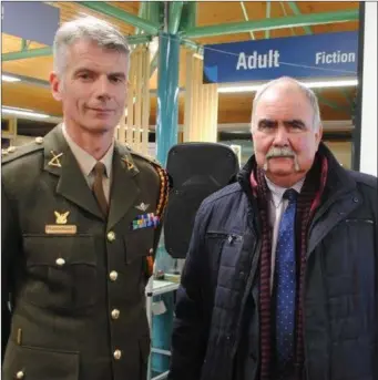  ??  ?? Lt. Col. Mark Prendergas­t pictured alongside Mark Minihan of New Ross at the Graiguenam­anagh Historical Society recent military talk in the local library .