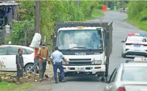  ?? Ronald Kumar ?? Nasinu Town Council workers during garbage collection at Caubati road in Nasinu on 22 September, 2021. Photo: