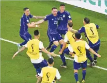  ?? ?? Argentina’s midfielder Alexis Mac Allister (C) celebrates with teammates after scoring his team’s first goal against Poland.