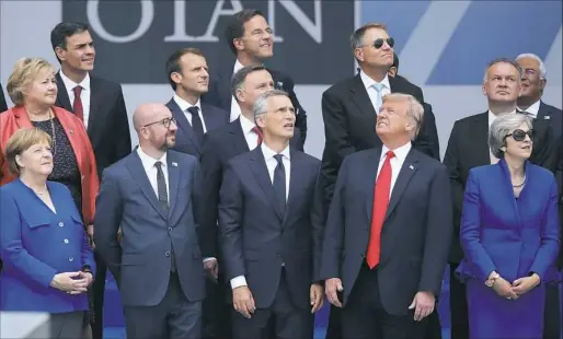  ?? Sean Gallup/Getty Images ?? President Donald Trump stands with European leaders at the NATO summit Wednesday in Brussels, Belgium.