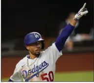  ?? (AP/Eric Gay) ?? Mookie Betts of the Los Angeles Dodgers watches the ball after hitting a home run during the Dodgers’ victory over the Tampa Bay Rays on Tuesday night in Game 1 of the World Series in Arlington, Texas.