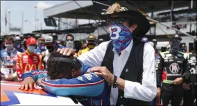  ?? JOHN BAZEMORE - THE ASSOCIATED PRESS ?? NASCAR driver Bubba Wallace is consoled by team owner Richard Petty, right, prior to the start of the NASCAR Cup Series at the Talladega Superspeed­way in Talladega, Ala., Monday, June 22, 2020. In an extraordin­ary act of solidarity with Wallace, NASCAR’s only Black driver, dozens of drivers pushed his car to the front of the field before Monday’s race.