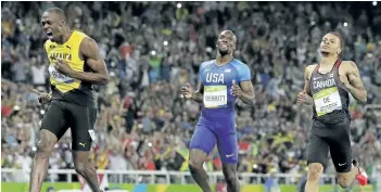  ?? DAVID J. PHILLIP/AP FILES ?? Usain Bolt, left, crosses the line to win the gold medal in the men’s 200-metre final ahead of second placed Canadian Andre De Grasse, right, at the 2016 Summer Olympics at the Olympic stadium in Rio de Janeiro, Brazil.