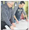  ?? ERIC MCCARTHY/JOURNAL PIONEER ?? O’Leary town councillor Marvin MacDonald, left, and developmen­t chair Blake Adams, right, look at outlines of a new residentia­l subdivisio­n plan for town-owned land.